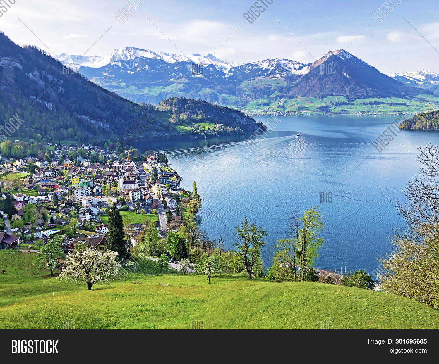 Snow-capped mountains reflecting in the waters of Lake Lucerne, Switzerland.